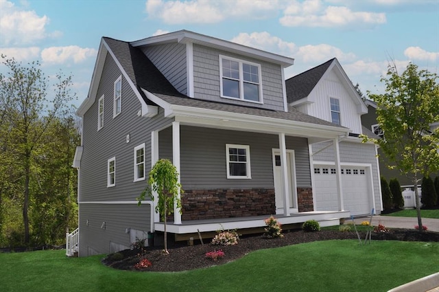 27 Willow Pond Cir Unit 27, Medway, MA 02053 - view of front of home featuring a porch, a front lawn, driveway, a shingled roof, and stone siding