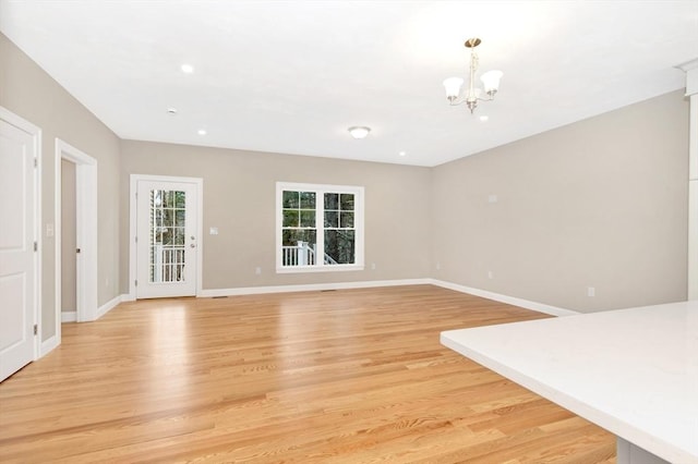 27 Willow Pond Cir Unit 27, Medway, MA 02053 - unfurnished living room with a chandelier, light wood-style flooring, baseboards, and recessed lighting
