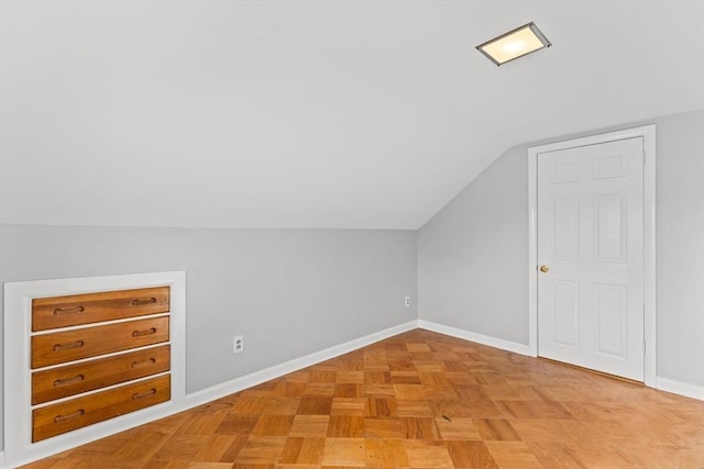 bonus room featuring baseboards and lofted ceiling