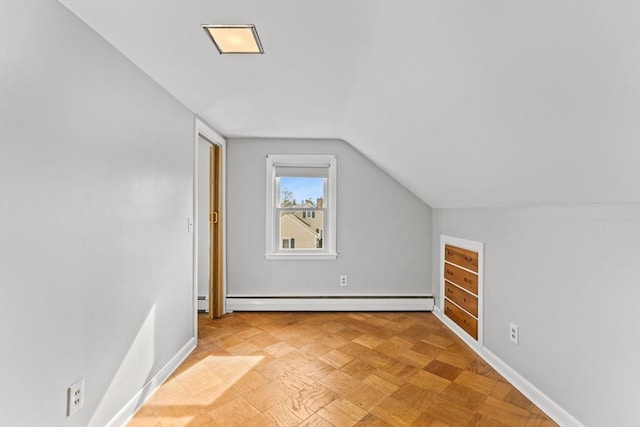 additional living space with baseboards, a baseboard heating unit, and lofted ceiling