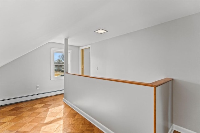 hallway with lofted ceiling, baseboards, and a baseboard radiator