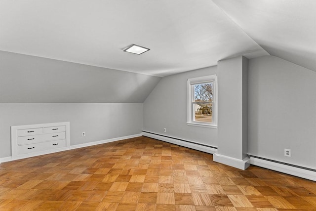 additional living space with vaulted ceiling, baseboards, and a baseboard radiator