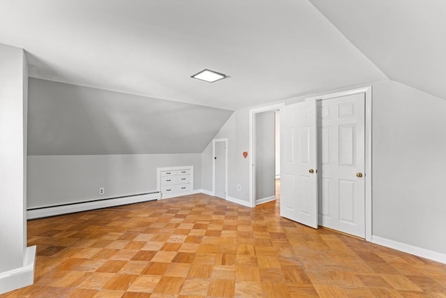 bonus room featuring a baseboard radiator, baseboards, and vaulted ceiling