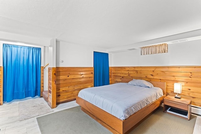 bedroom featuring visible vents and wood walls