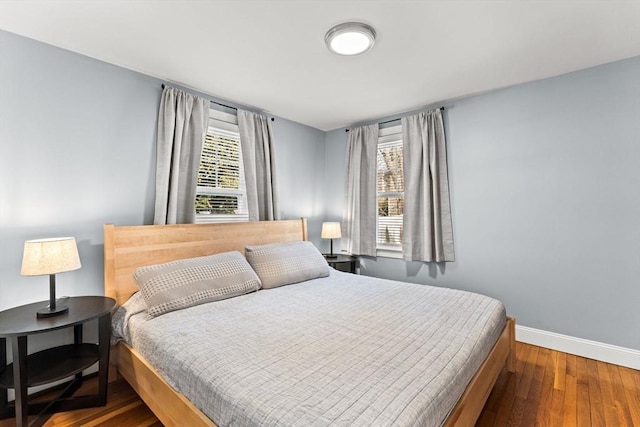 bedroom with wood finished floors and baseboards