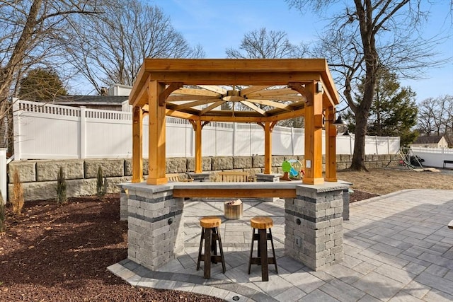 view of patio / terrace featuring outdoor dry bar and a fenced backyard