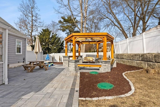 view of patio featuring a gazebo, outdoor dining area, and a fenced backyard