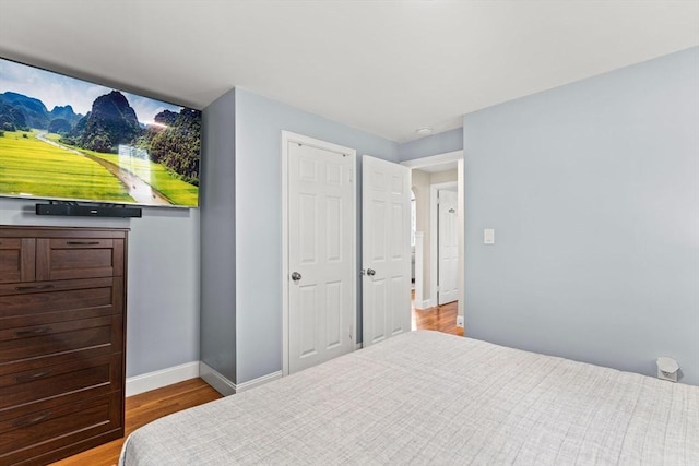 bedroom featuring light wood-style flooring and baseboards