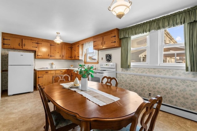 dining area with a baseboard radiator and a wealth of natural light