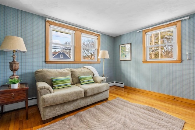 sitting room featuring a baseboard radiator and hardwood / wood-style floors