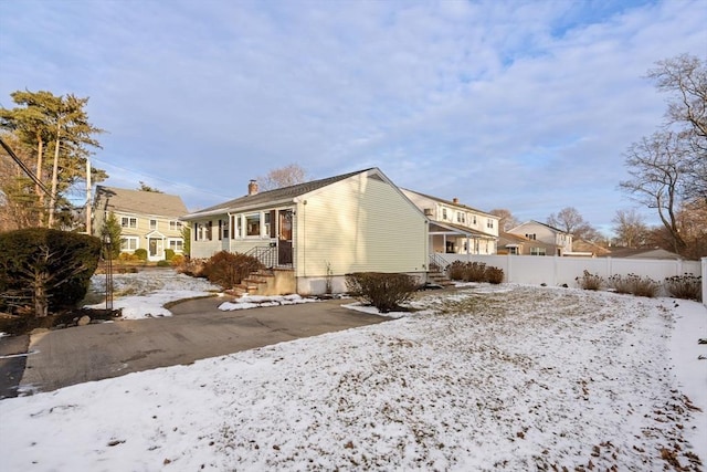 view of snow covered rear of property