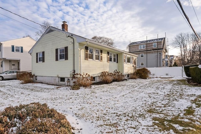 view of snow covered back of property