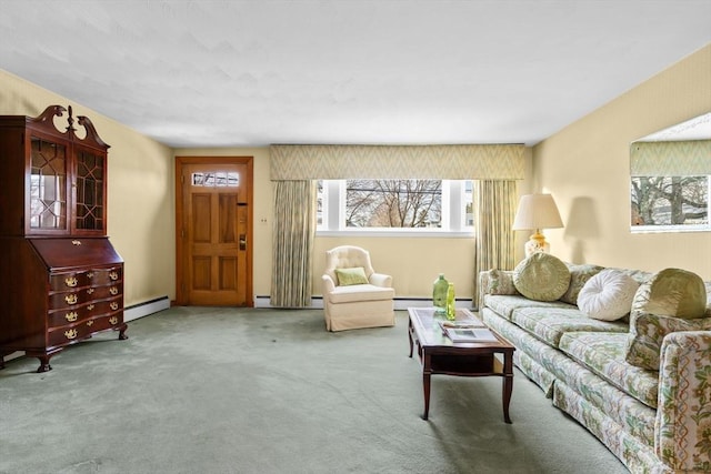 living room with a baseboard heating unit and carpet