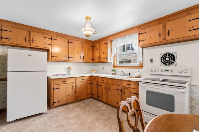 kitchen with sink, white appliances, and pendant lighting