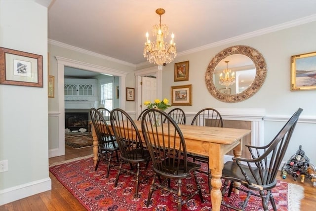 6 Willow St, Wellesley, MA 02481 - dining room featuring a chandelier, wood finished floors, ornamental molding, a fireplace, and baseboards