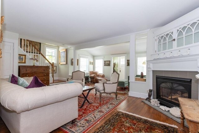 6 Willow St, Wellesley, MA 02481 - living area with stairway, wood finished floors, a tile fireplace, and healthy amount of natural light