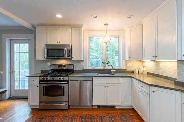 6 Willow St, Wellesley, MA 02481 - kitchen featuring appliances with stainless steel finishes, a chandelier, dark wood-type flooring, a sink, and white cabinetry