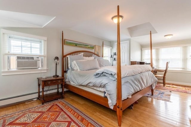 6 Willow St, Wellesley, MA 02481 - bedroom featuring multiple windows, light wood finished floors, baseboard heating, cooling unit, and vaulted ceiling