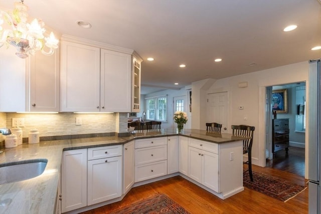 6 Willow St, Wellesley, MA 02481 - kitchen with wood finished floors, white cabinets, a peninsula, tasteful backsplash, and recessed lighting