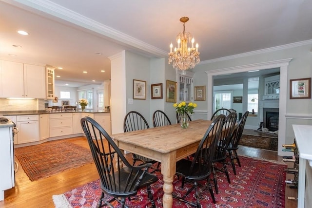6 Willow St, Wellesley, MA 02481 - dining area featuring a chandelier, light wood-type flooring, a fireplace, crown molding, and recessed lighting