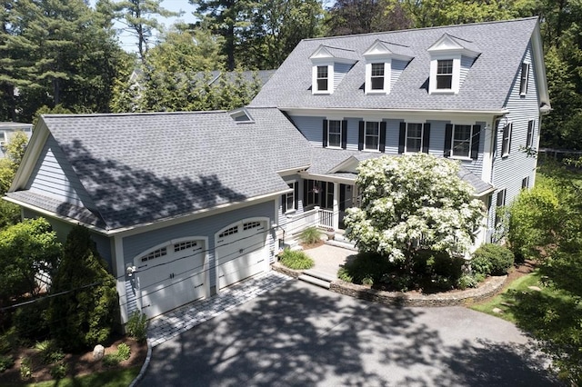 127 Shade St, Lexington, MA 02421 - view of front of property featuring a shingled roof, concrete driveway, a garage, and view of scattered trees