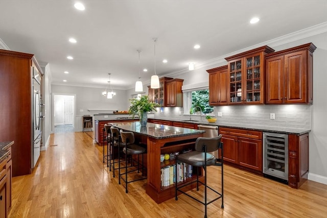 127 Shade St, Lexington, MA 02421 - kitchen featuring wine cooler, a breakfast bar area, a sink, tasteful backsplash, and stainless steel dishwasher