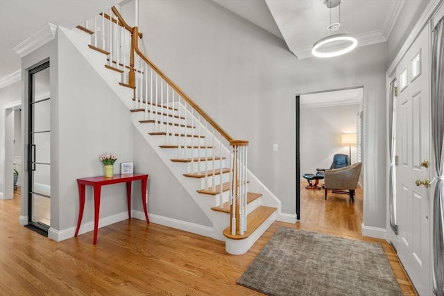 127 Shade St, Lexington, MA 02421 - foyer featuring wood finished floors, stairway, ornamental molding, and baseboards