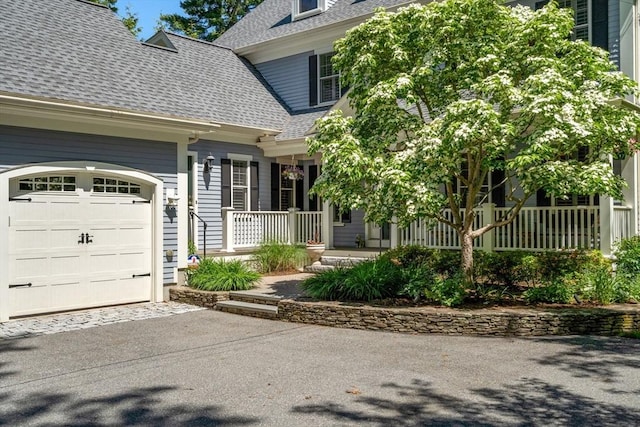 127 Shade St, Lexington, MA 02421 - view of front of property with roof with shingles, covered porch, a garage, and asphalt driveway