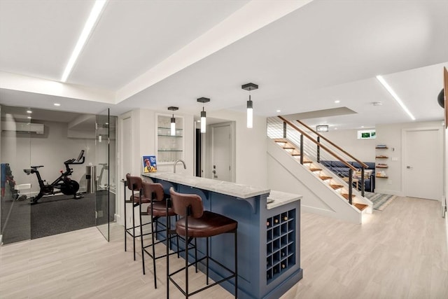 127 Shade St, Lexington, MA 02421 - indoor wet bar featuring light wood finished floors, stairs, hanging light fixtures, an AC wall unit, and recessed lighting