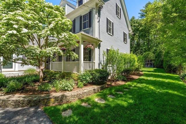 127 Shade St, Lexington, MA 02421 - view of side of home with a lawn and a porch