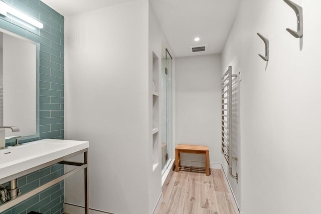 127 Shade St, Lexington, MA 02421 - bathroom with wood finished floors, recessed lighting, a shower, and tile walls