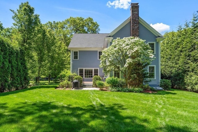 127 Shade St, Lexington, MA 02421 - back of property with a lawn and a chimney