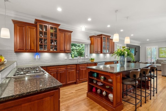 127 Shade St, Lexington, MA 02421 - kitchen with appliances with stainless steel finishes, a kitchen island, a sink, backsplash, and open shelves
