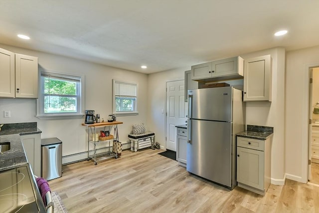 18 Emerald Ave, Webster, MA 01570 - kitchen with freestanding refrigerator, stove, dark stone countertops, light wood-style floors, and recessed lighting