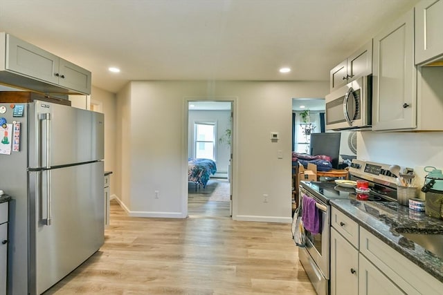 18 Emerald Ave, Webster, MA 01570 - kitchen with appliances with stainless steel finishes, light wood-type flooring, recessed lighting, and dark stone countertops