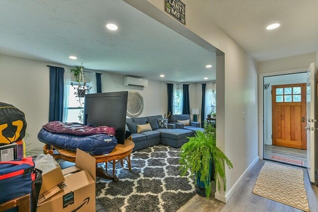 18 Emerald Ave, Webster, MA 01570 - living area featuring a wall mounted air conditioner, wood finished floors, and recessed lighting