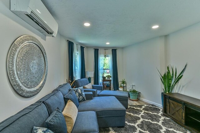 18 Emerald Ave, Webster, MA 01570 - living room with a wall unit AC, recessed lighting, and wood finished floors