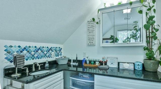 18 Emerald Ave, Webster, MA 01570 - bathroom with vaulted ceiling, vanity, and backsplash