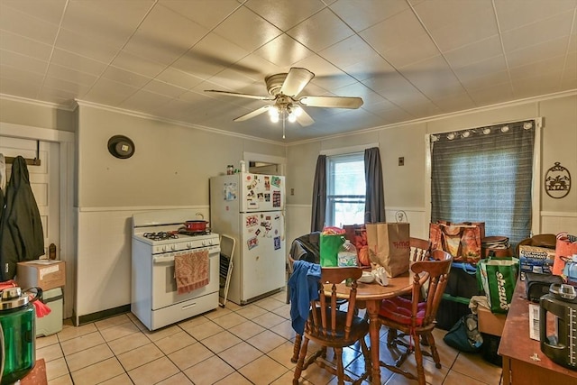 18 Emerald Ave, Webster, MA 01570 - dining space with a wainscoted wall, light tile patterned floors, crown molding, and ceiling fan