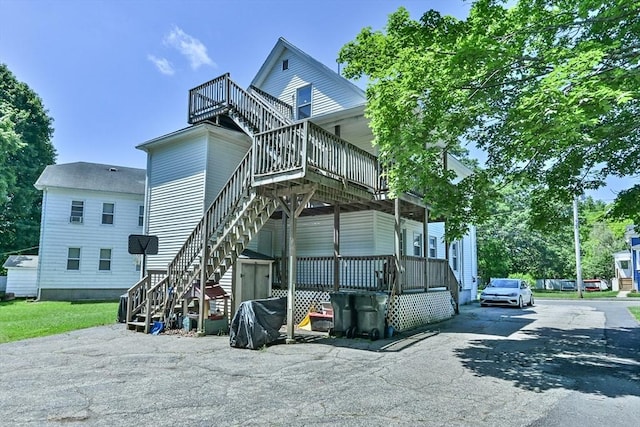 18 Emerald Ave, Webster, MA 01570 - rear view of property featuring stairway, a deck, and driveway