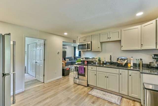 18 Emerald Ave, Webster, MA 01570 - kitchen featuring stainless steel appliances, light wood finished floors, dark stone counters, and recessed lighting