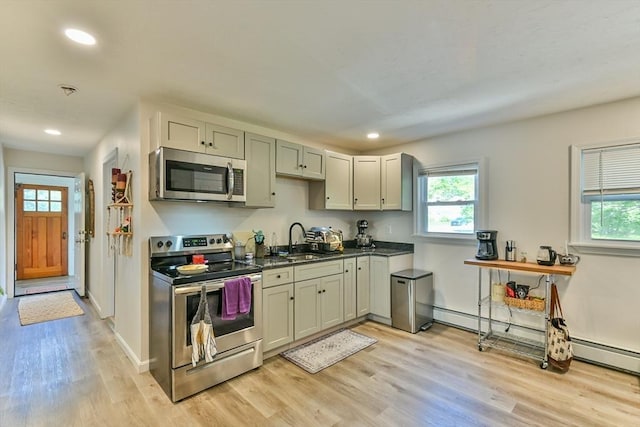 18 Emerald Ave, Webster, MA 01570 - kitchen featuring appliances with stainless steel finishes, light wood-style floors, plenty of natural light, dark countertops, and recessed lighting
