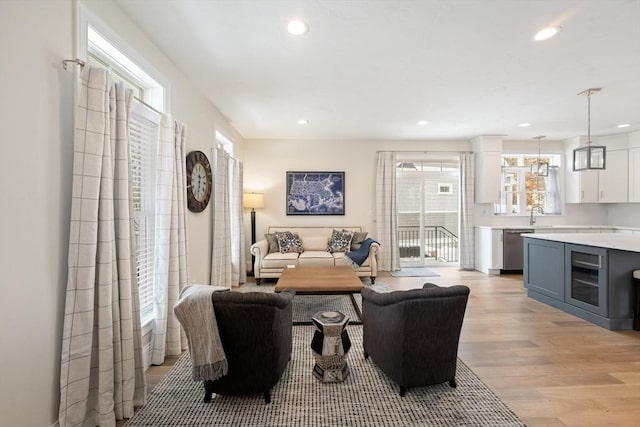 living room featuring wine cooler and light wood-type flooring