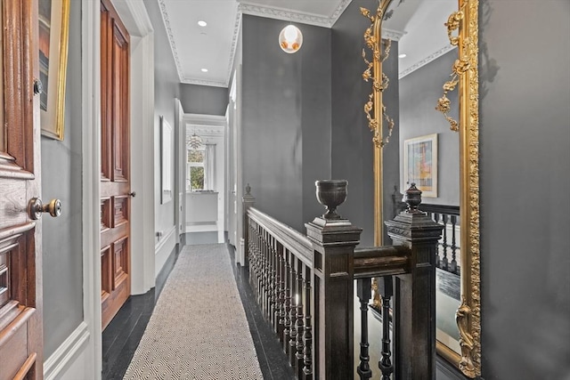 hall with recessed lighting, baseboards, an upstairs landing, and ornamental molding