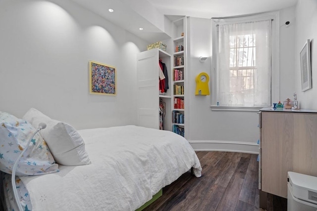 bedroom with baseboards, recessed lighting, and dark wood-style flooring