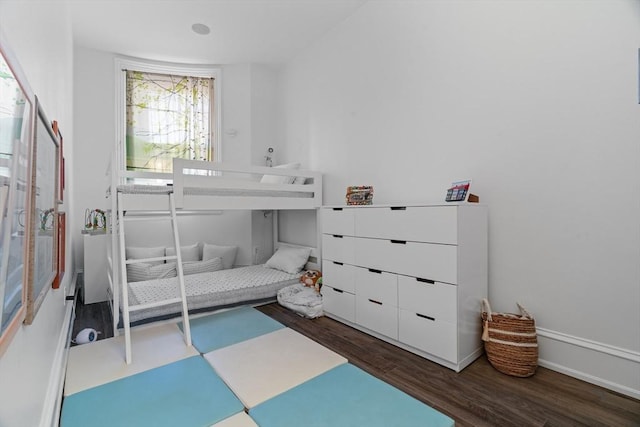 bedroom featuring baseboards and wood finished floors