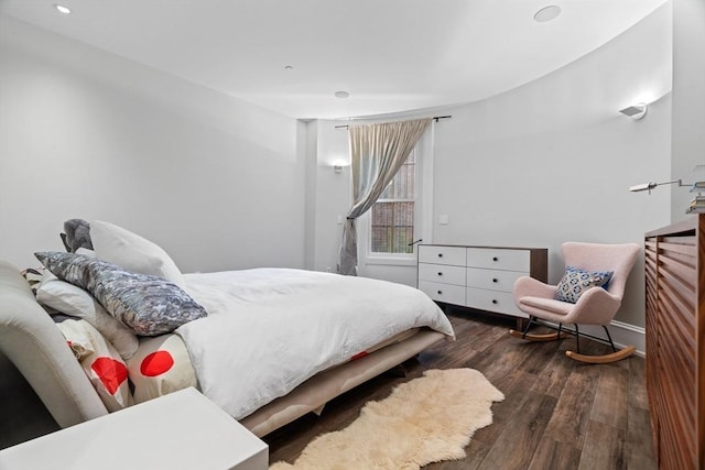 bedroom featuring baseboards, recessed lighting, and wood finished floors