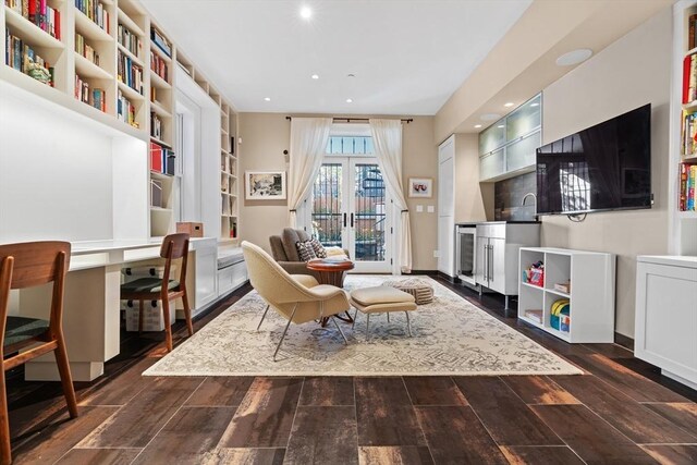 sitting room featuring french doors, recessed lighting, dark wood-type flooring, and beverage cooler