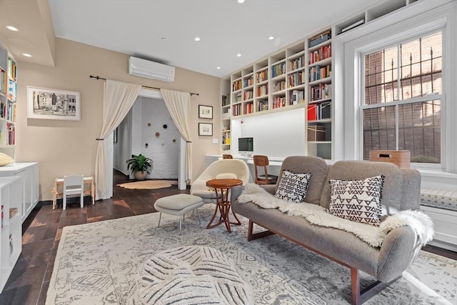 living area featuring built in features, recessed lighting, baseboards, a wall unit AC, and wood finished floors