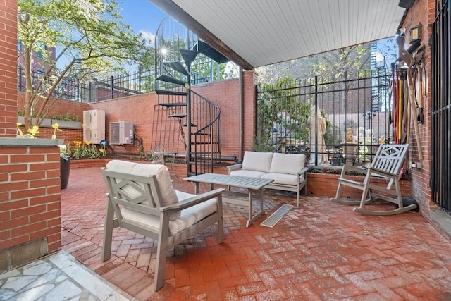 view of patio featuring fence, an outdoor hangout area, and stairs